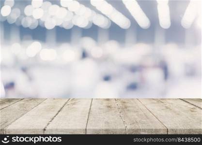 Empty wooden table and Blurred background - Store of shopping mall blur background bokeh with display montage for product.