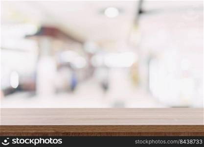 Empty wooden table and Blurred background - Store of shopping mall blur background bokeh with display montage for product.