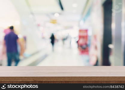 Empty wooden table and Blurred background - Store of shopping mall blur background bokeh with display montage for product.