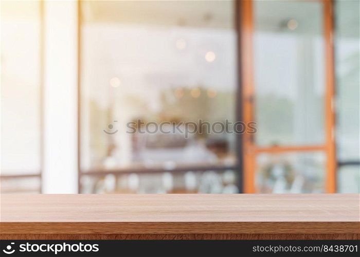 Empty wooden table and blurred people in coffee shop background, product display montage.