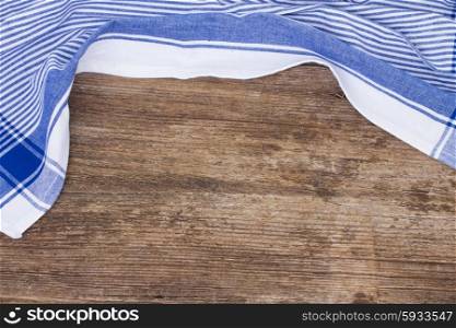 empty wooden table and cloth blue napkin