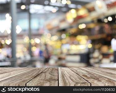 Empty wooden table and restaurant blur background and have copy space for your design concept.