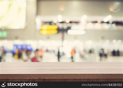 Empty wooden table for product placement or montage and blurred terminal department at airport background.
