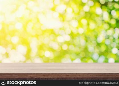 Empty wooden table for product placement or montage and green boken blurred background.