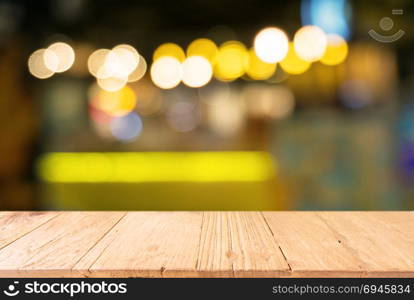 Empty wooden table in front of abstract blurred background of bokeh light . can be used for display or montage your products.Mock up for display of product