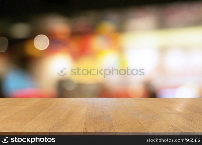 Empty wooden table in front of abstract blurred background of bokeh light . can be used for display or montage your products.Mock up for display of product