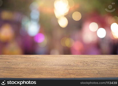 Empty wooden table in front of abstract blurred background of coffee shop . can be used for display or montage your products.Mock up for display of product.