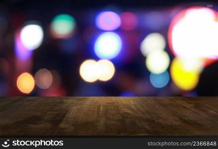 Empty wooden table in front of abstract blurred background of coffee shop . wood table in front can be used for display or montage your products.Mock up for display of product