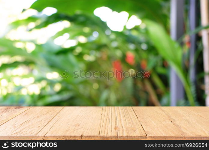 Empty wooden table in front of abstract blurred background of coffee shop . can be used for display or montage your products.Mock up for display of product