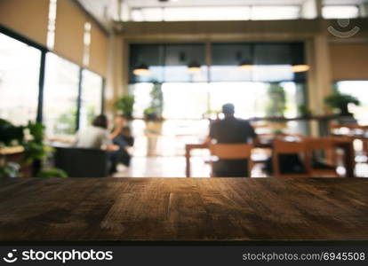 Empty wooden table in front of abstract blurred background of coffee shop . can be used for display or montage your products.Mock up for display of product.