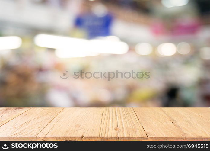 Empty wooden table in front of abstract blurred background of coffee shop . can be used for display or montage your products.Mock up for display of product