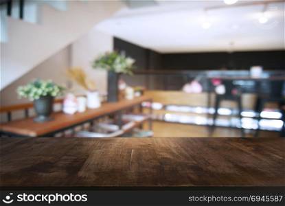 Empty wooden table in front of abstract blurred background of coffee shop . can be used for display or montage your products.Mock up for display of product
