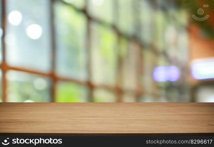 Empty wooden table in front of abstract blurred background of coffee shop . wood table in front can be used for display or montage your products.Mock up for display of product 