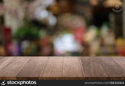 Empty wooden table in front of abstract blurred background of coffee shop . wood table in front can be used for display or montage your products.Mock up for display of product
