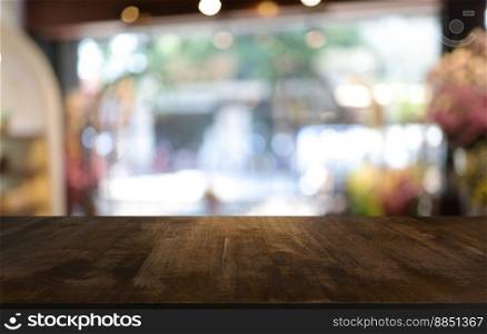 Empty wooden table in front of abstract blurred background of coffee shop . wood table in front can be used for display or montage your products.Mock up for display of product 