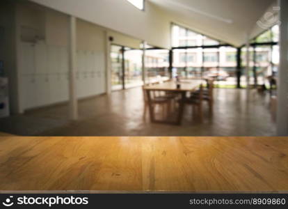 Empty wooden table in front of abstract blurred background of coffee shop . can be used for display or montage your products.Mock up for display of product