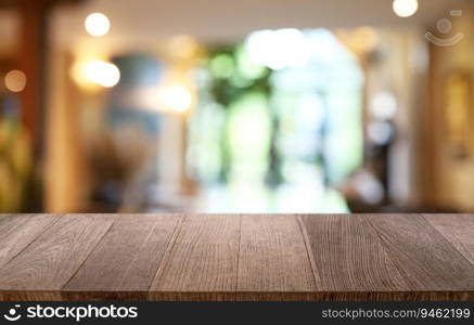 Empty wooden table in front of abstract blurred background of coffee shop . wood table in front can be used for display or montage your products.Mock up for display of product 