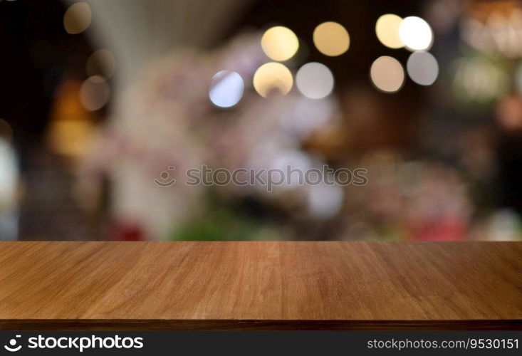 Empty wooden table in front of abstract blurred background of coffee shop . wood table in front can be used for display or montage your products.Mock up for display of product 