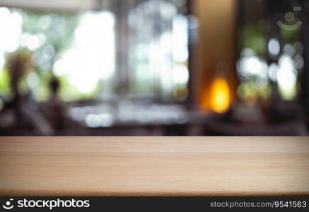 Empty wooden table in front of abstract blurred background of coffee shop . wood table in front can be used for display or montage your products.Mock up for display of product 