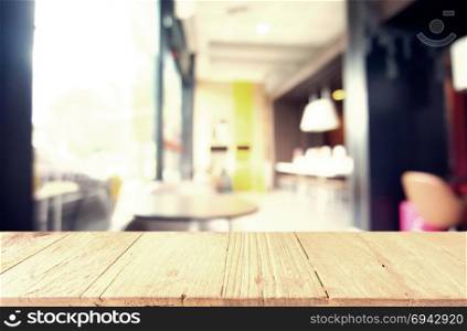 Empty wooden table in front of abstract blurred background of restaurant . can be used for display or montage your products.Mock up for display of counter