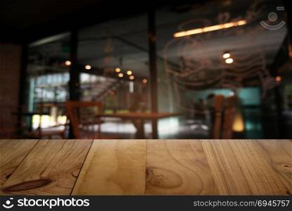 Empty wooden table in front of abstract blurred background of restaurant . can be used for display or montage your products.Mock up for display of counter