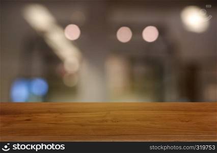Empty wooden table in front of abstract blurred background of restaurant, cafe and coffee shop interior. can be used for display or montage your products - Image