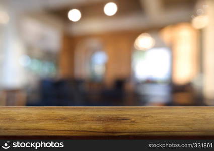 Empty wooden table in front of abstract blurred background of restaurant, cafe and coffee shop interior. can be used for display or montage your products - Image