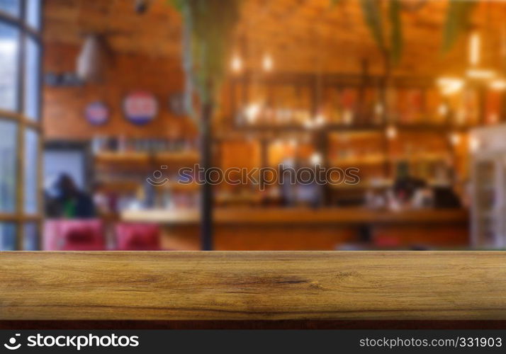 Empty wooden table in front of abstract blurred background of restaurant, cafe and coffee shop interior. can be used for display or montage your products - Image