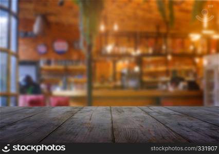 Empty wooden table in front of abstract blurred background of restaurant, cafe and coffee shop interior. can be used for display or montage your products - Image