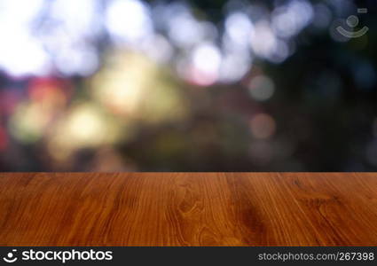Empty wooden table in front of abstract blurred green of garden and house background. For montage product display or design key visual layout - Image