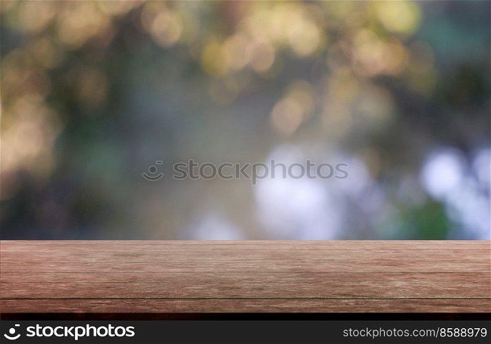 Empty wooden table in front of abstract blurred green of garden and trees background. For montage product display or design key visual layout - Image