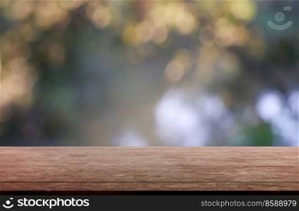 Empty wooden table in front of abstract blurred green of garden and trees background. For montage product display or design key visual layout - Image