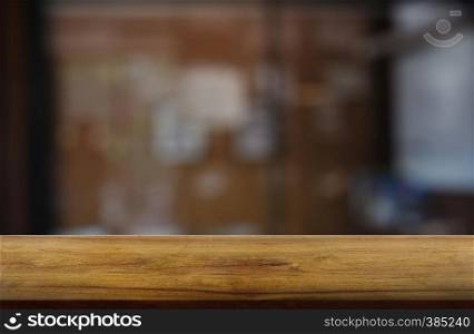 Empty wooden table in front of abstract blurred indoor house room interior background. For montage product display or design key visual layout - Image