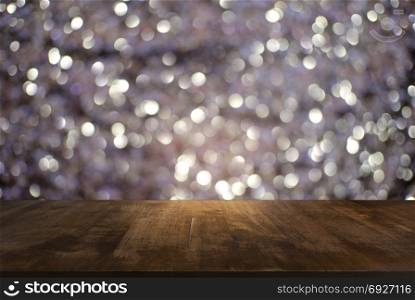 Empty wooden table in front of black and gold glitter lights background . can be used for display or montage your products.Mock up for display of product