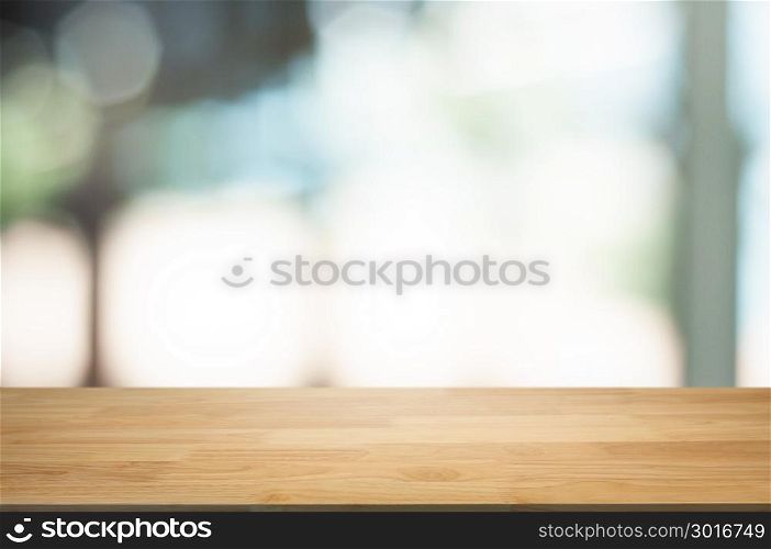 empty wooden table in front of blur montage abstract background