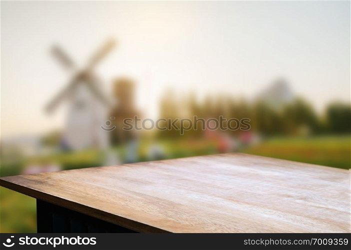 empty wooden table over blur mantage garden background