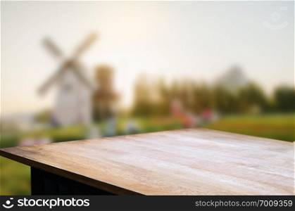 empty wooden table over blur mantage garden background