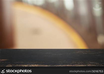 empty wooden table over blur montage abstract background
