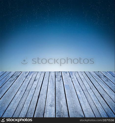 Empty wooden table over sky background early morning