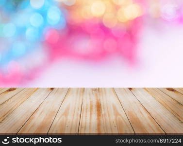 Empty wooden table top with abstract Christmas bokeh lights background, can be used for montage or display your products
