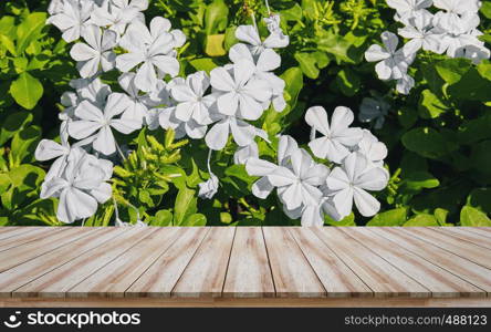 Empty wooden table top with beautiful white flower perspective background, Design for montage products display or mock-up visual layout for promotion