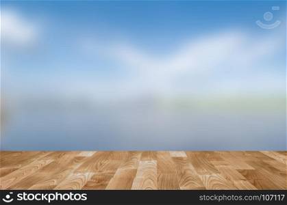 Empty wooden table with blue sky bokeh