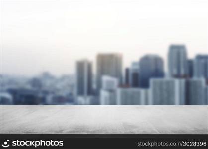 empty wooden table with blur montage urban building background