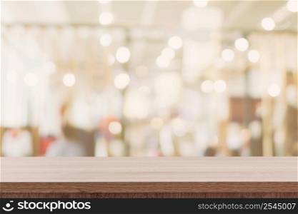 Empty wooden table with blurred abstract people on cafe on restaurant background.