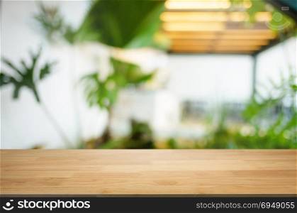 empty wooden table with blurred montage coffee shop cafe / restaurant background
