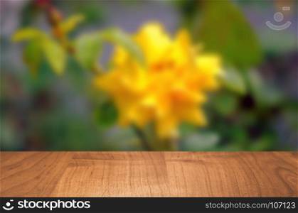 Empty wooden table with garden bokeh for a catering or food background