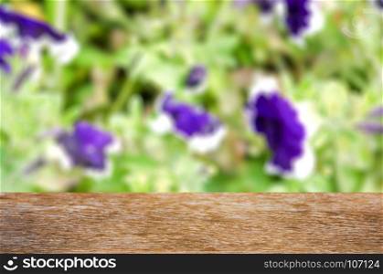Empty wooden table with garden bokeh for a catering or food background
