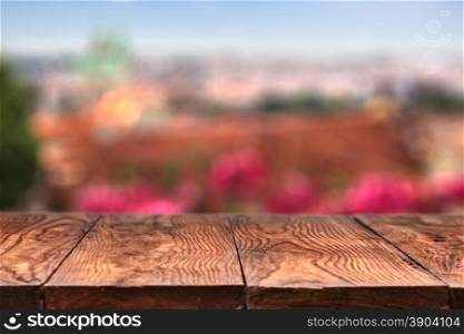 Empty wooden table with Prague on background. Empty wooden table with Prague on background with natural bokeh