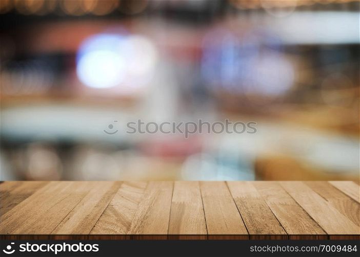 empty wooden tabletop over blur hypermarket background.