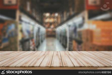 Empty wooden tabletop with blurred supermarket background for montage products display or design key visual layout
